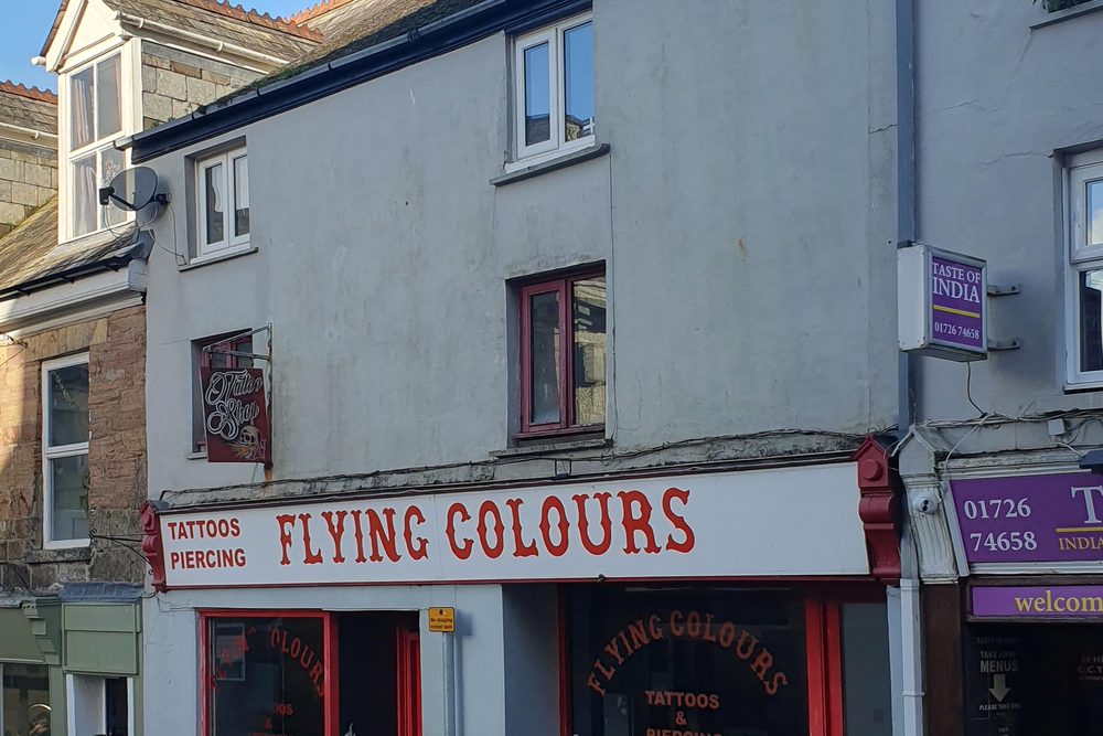 The shopfront of an independent tattoo studio on a British high street